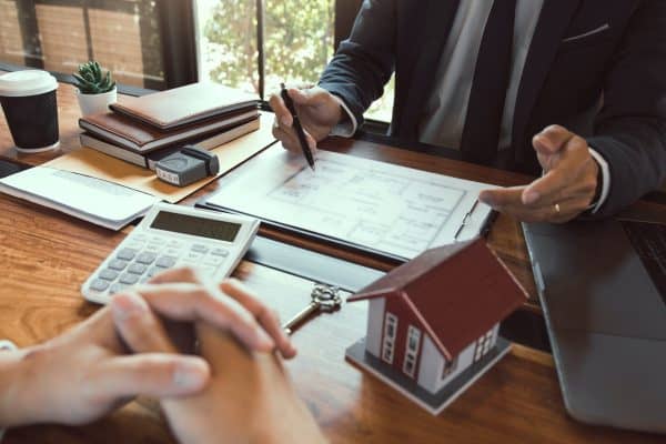 Identifying Your COI 2 Property sales staff submit land mortgage contract documents to home buyers for sign.
